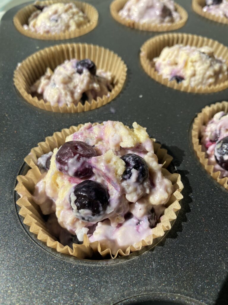 Raw Lemon Blueberry Muffin batter in the muffin tin before baking