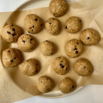 Plate full of chocolate chip cookie dough protein balls