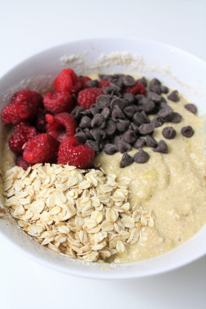 adding in the raspberries, chcoolate chips, and oats to the batter