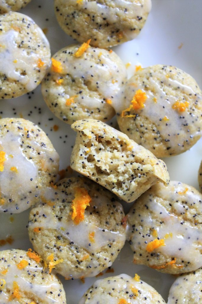 A close up of a bite of a gluten free orange poppy seed muffin 