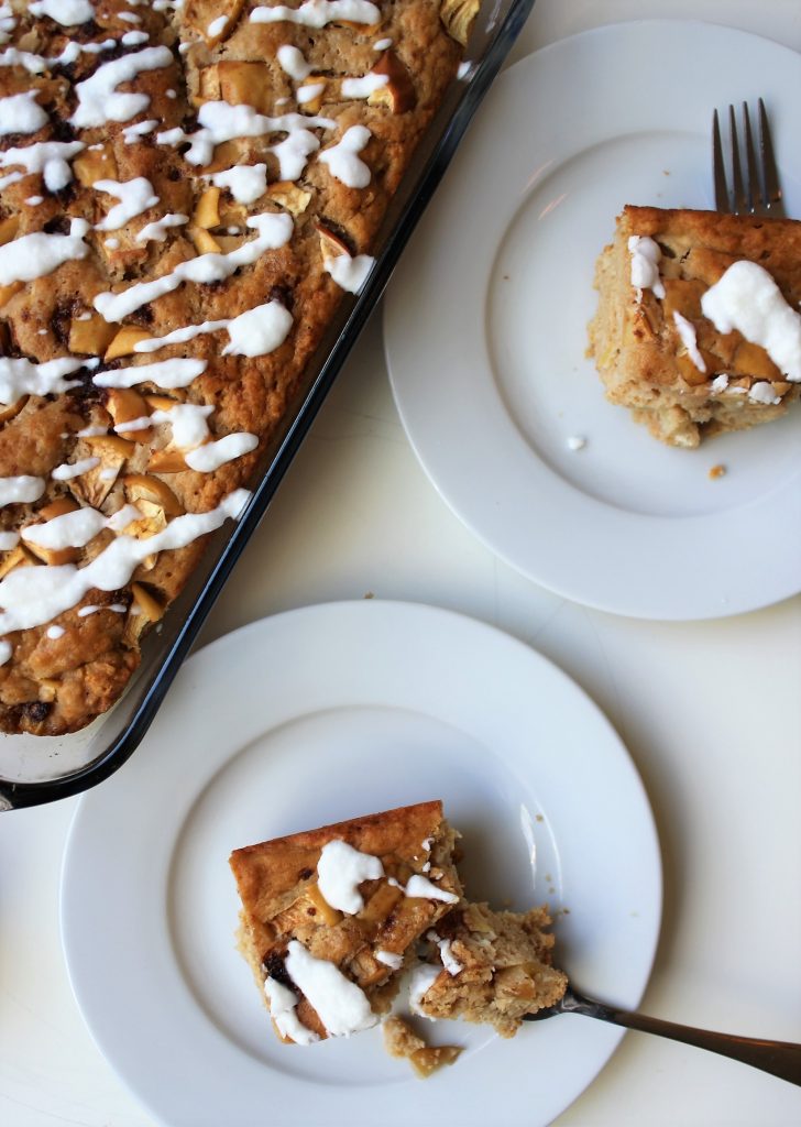 This Apple Yogurt Cake Recipe is delicious, moist, and super easy. It is refined sugar free, nut free, and can easily be made gluten free with a gluten free flour option. It comes together in only a few minutes and makes a delicious, healthy snack! #applecake #yogurtcake #appleyogurtcake #snackingcake #applecinnamoncake