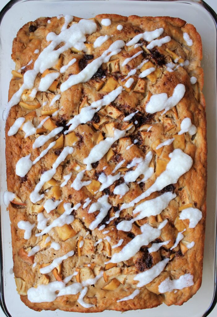 This Apple Yogurt Cake Recipe is delicious, moist, and super easy. It is refined sugar free, nut free, and can easily be made gluten free with a gluten free flour option. It comes together in only a few minutes and makes a delicious, healthy snack! #applecake #yogurtcake #appleyogurtcake #snackingcake #applecinnamoncake