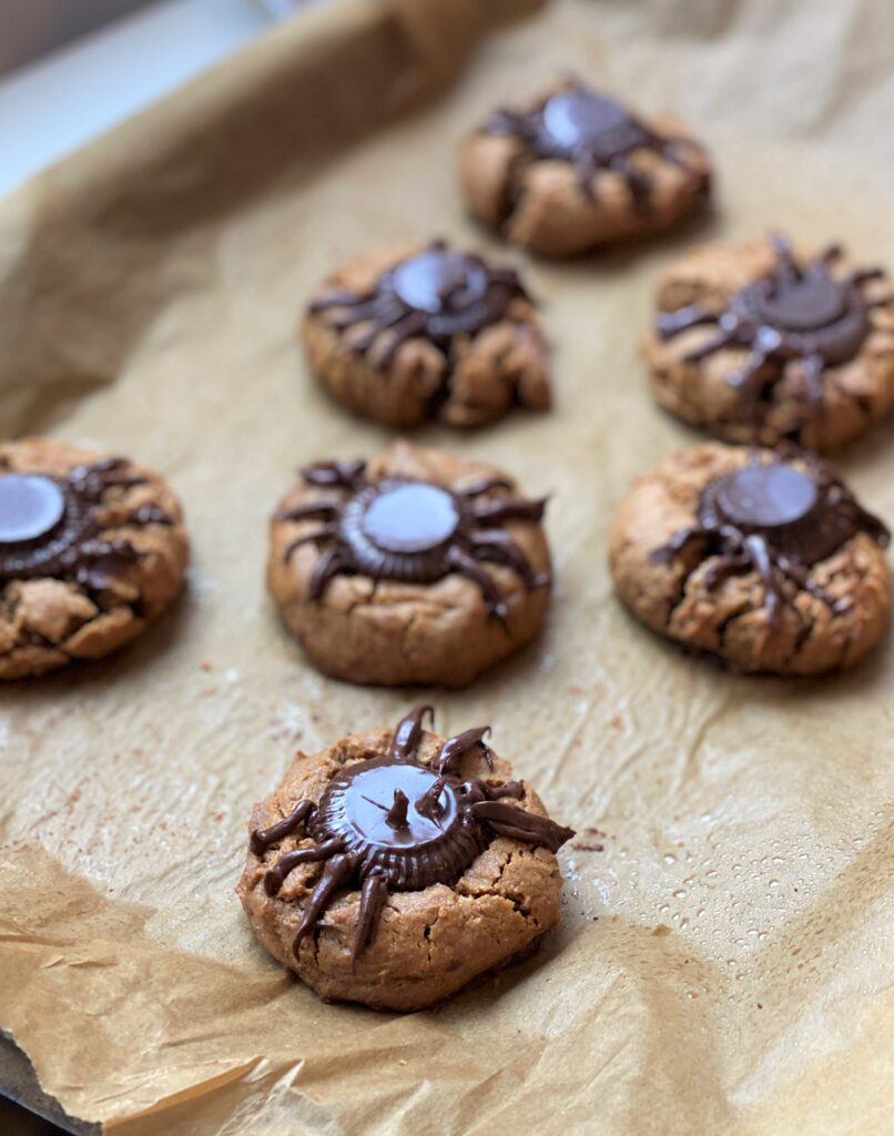 just made peanut butter spider cookies, chocolate is melting on top of the cookies