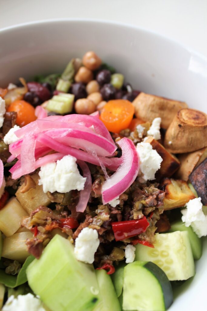 grain bowl topped with some pink pickled onions