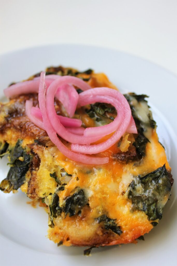 strata with pickled onions on top