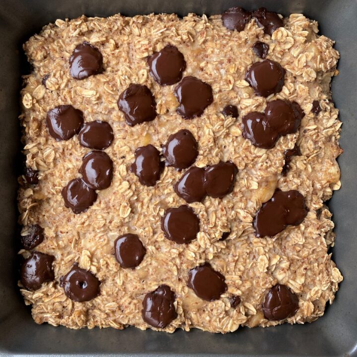 Close up of baking dish after baking vegan banana bread oat with melted chocolate chips on top